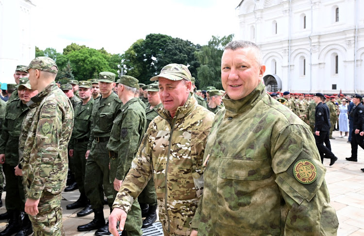 Alexei Rubezhnoi, chief of the Russian Presidential Security Service (right), waits before President Vladimir Putin's address paying honour to armed forces, that upheld order during recent mutiny, in Cathedral Square at the Kremlin in Moscow, Russia, on June 27 2023. Picture: SPUTNIK/POOL via REUTERS