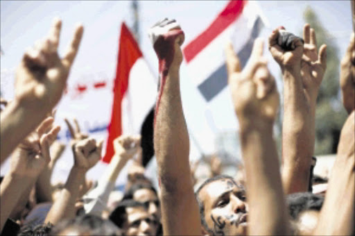 CHAOS: Anti-government protesters shout slogans during a demonstration to demand the ouster of Yemen's President Ali Abdullah Saleh in Sanaa on Sunday. PHOTO: REUTERS