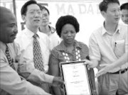 UNITY: Mandla Zikhali, chairman of the Madadeni community policing forum, Zhang Lianyun, the Chinese consul-general, Mayor Phumzile Mbatha-Cele and Robert Han Zhiliang, chairman of the Chinese community policing forum. Pic. Mhlaba Memela. © Sowetan.