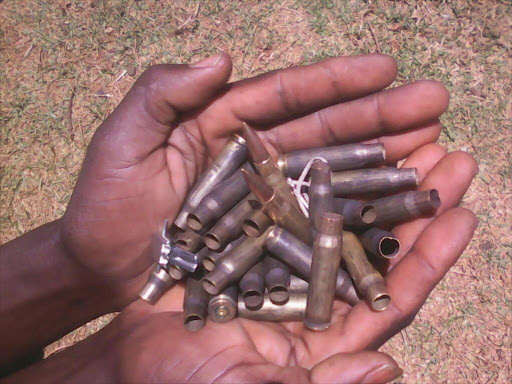 A resident of Kipsaiya village displays ammunition cartridges after police officers stormed the village and shot in the air several times, Sunday February 25, 2018. /STEPHEN RUTTO