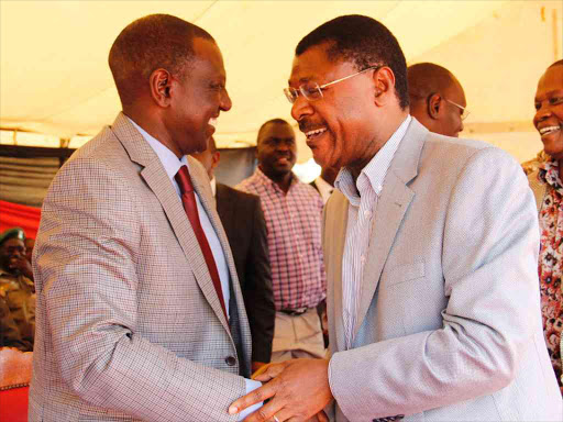 DP William Ruto chats with Bungoma senator Moses Wetangula during the launch of seed fund for bungoma county bodaboda sacco.PHOTO/Charles Kimani/DPPS