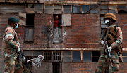 Troops patrol the streets of Alexandra during the lockdown. Some soldiers have been accused of being heavy-handed while civilians who complain about the soldiers have been labelled anarchists.