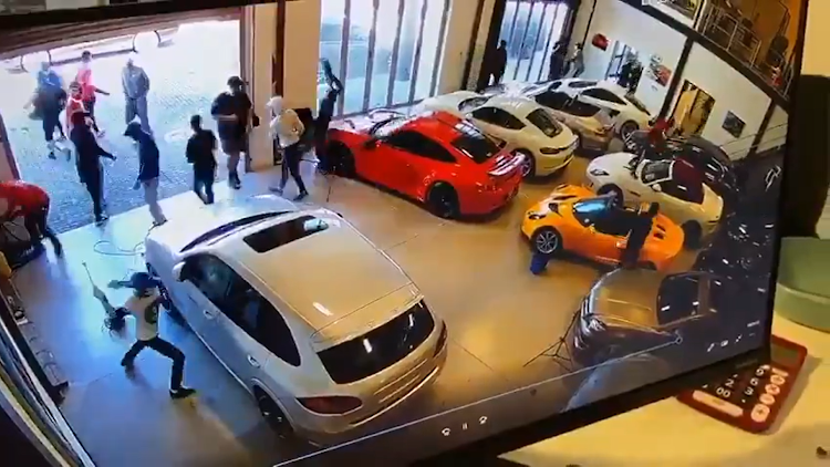 Luxury cars being vandalised at a Cape Town dealership on Wednesday February 17 2021.