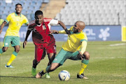 HANDS ON: Wandisile Letlabika of Bafana is held back by  Nick Curpanen of Mauritius in the first leg  in Soweto Photo: BackpagePix