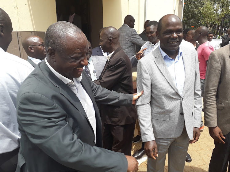 Bungoma chief of staff Allan Chenane with IEBC chairman Wafula Chebukati at the county offices on Thursday, August 8