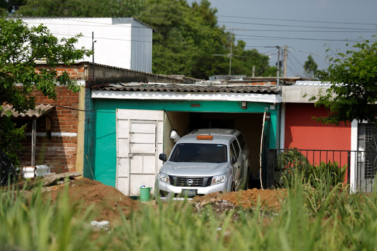 A Forensics Institute car is seen where authorities are excavating a clandestine cemetery discovered at the house of a former police officer and containing as many as 40 bodies, most of them believed to be women in Chalchuapa, El Salvador May 20, 2021.