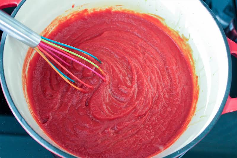 Adding Tomato Sauce To The Puree.