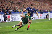 The Springboks' Kurt-Lee Arendse scores his team's first try in the Rugby World Cup quarterfinal against France at Stade de France in Paris on Sunday night.