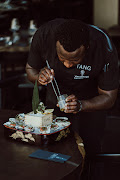 Chef Vixa Kalenga plates up Tang’s signature shies truffle oysters.