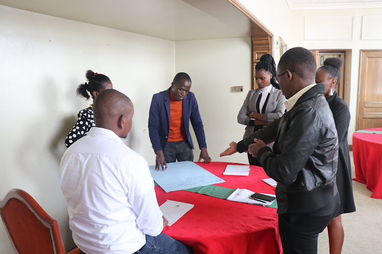 Journalists in a group assignment during Amwik's reporting on Online Violence Against Women workshop at a Nairobi hotel on December 6, 2022.