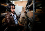 Rodolfo Salas-Gismondi, founder and director of the paleontology department at the Museum of Natural History of the Universidad Nacional Mayor de San Marcos, shows the fossil remains of a crocodile that inhabited the planet seven million years ago, giving scientists clues about how modern day crocodiles, who live in freshwater ecosystems, come from the sea, in Lima, Peru May 16, 2022. 