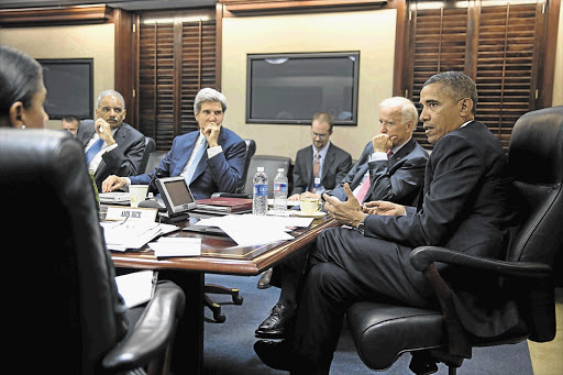 US President Barack Obama, foreground, vice-president Joe Biden to his right, Secretary of State John Kerry and Attorney General Eric Holder, left, discuss a strike on Syria