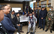 Nepal's Prime Minister Pushpa Kamal Dahal, also known as Prachanda, watches a live TV broadcast after an aircraft carrying 72 people crashed in Pokhara in western Nepal on January 15 2023.