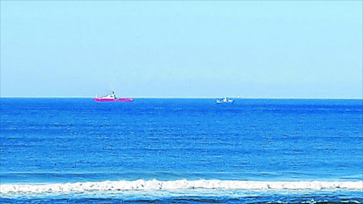 KEEPING AN EYE OUT: A fisherman snapped this shot of a fisheries patrol vessel, believed to be the Sarah Baartman, left, parked close to a suspected illegal trawler not far from the beach near Kob Inn yesterday. This is the first public evidence of a state fisheries patrol vessel stepping in to check on suspected illegal trawlers off the Wild Coast Picture SUPPLIED