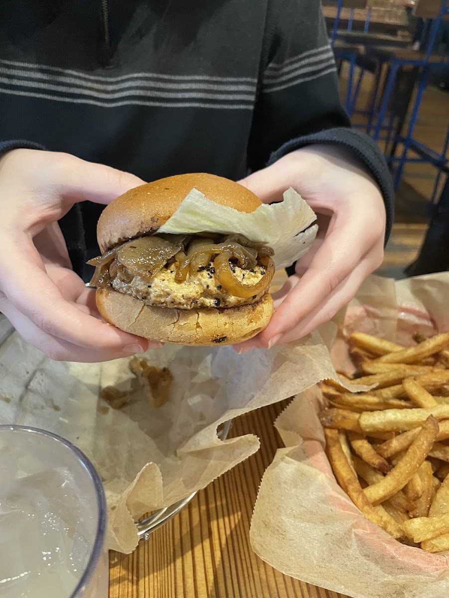 Chicken burger with caramelized onion and lettuce. Fries from a shared fryer.