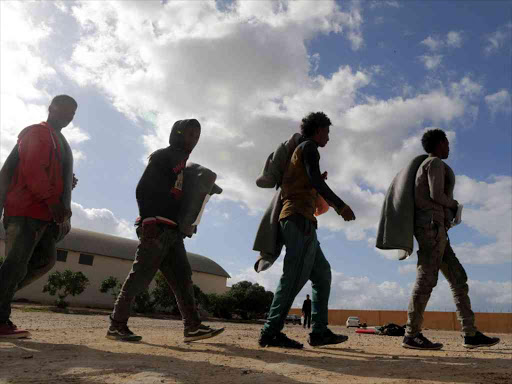 Migrants walk at a detention centre run by the Interior Ministry of Libya's eastern-based government, in Benghazi, Libya January 11, 2018. /Reuters