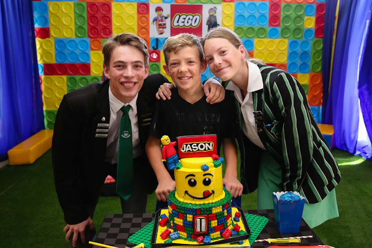 LEGO DREAM: Kirsten Bester, left, Jason Fourie, 11, and Tyra Roozendaal with the Lego cake at a special Lego Party organised by the Reach for a Dream organisation and Pearson High School Interact Club