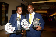 Mamelodi Sundowns star forward Percy Tau PSL pose with his trophies alongside his head coach Pitso Mosimane.     