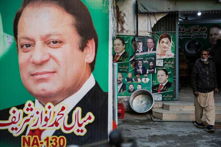 A man stands near an election banner of Pakistan’s former prime minister Nawaz Sharif in Lahore, Pakistan, on February 5 2024. Picture: NAVESH CHITRAKAR/REUTERS