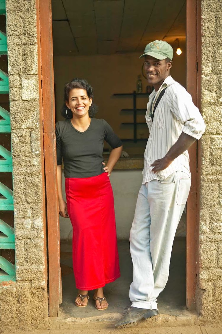 A Cuban woman and man in a doorway.