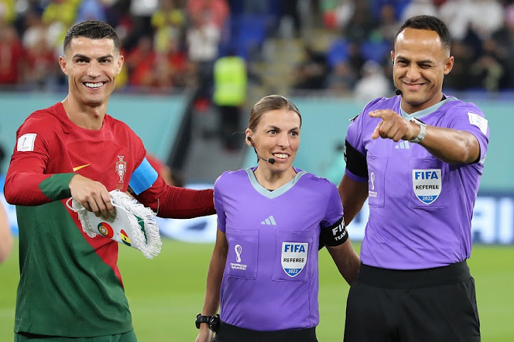 Cristiano Ronaldo of Portugal lines up alongside fourth official Stephanie Frappart of France referee Ismail Elfath of USA in the World Cup Group H match between Portugal and Ghana at Stadium 974 on November 24 2022.