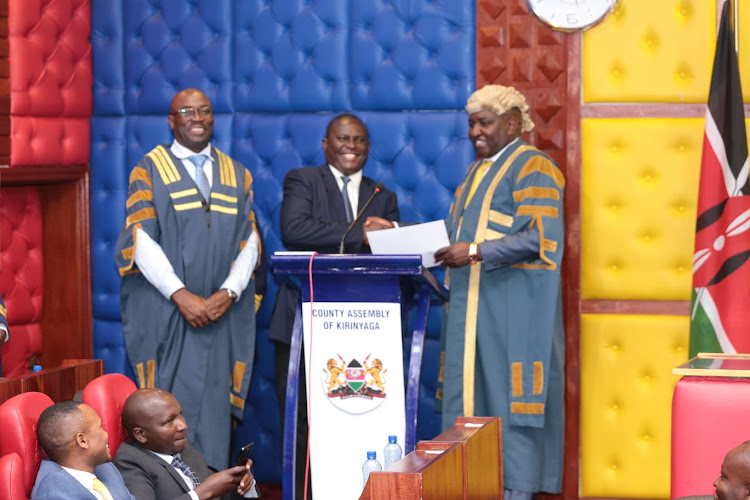 Speaker Murimi Muteti presents a certificate to his new deputy Njamumo Njinaro after he was sworn at the floor of the house.