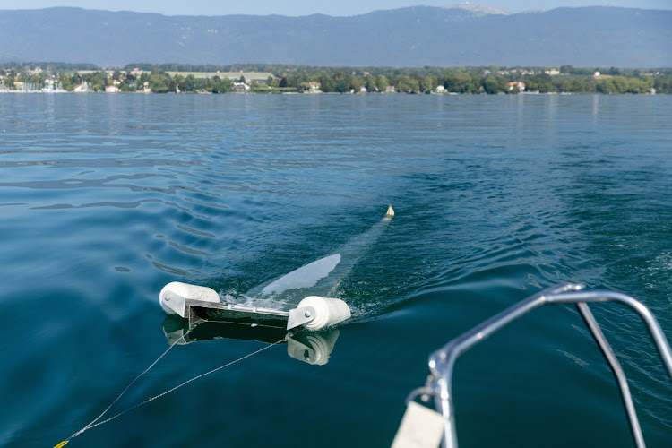 A device of the NGO Oceaneye collects plastic fragments in the water of Lake Leman (also known as Lake Geneva) in Founex, near Geneva, Switzerland in August 2023.