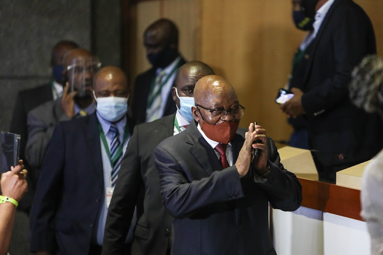 Former president Jacob Zuma offers a greeting on arrival at the venue for the state capture commission on November 16 2020, in Braamfontein, Johannesburg.