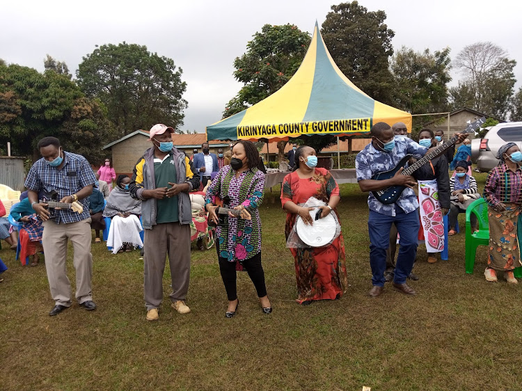 Kirinyaga governor Anne Waiguru plays a guitar during an event at Njuki-ini ward on Wednesday