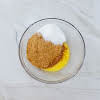 Thumbnail For Crushed Graham Crackers, Melted Margarine, And Sugar In A Bowl.