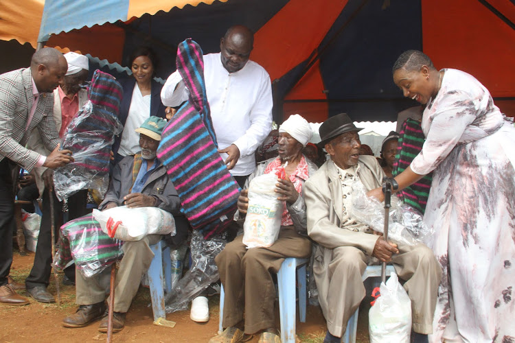 Ahadi Kenya CEO Stanley Kamau donates foodstuffs and blankets to elderly persons accompanied by Woman Representative Sabina Chege on Saturday