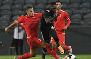 Ghazi Ayadi of Al Ittihad challenges Fortune Makaringe of Orlando Pirates on Sunday.