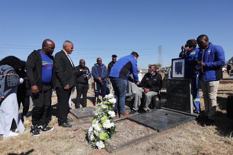 DA leader John Steenhuisen greets Michael Vilankulu, whose brother Japie Vilankulu passed away during the riots that preceded the June 16 uprising in Alexandra, at the Old Alexandra Cemetery in Johannesburg.