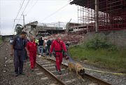 Emergency workers leave the scene as the search for survivors was called off after a three-storey building collapsed. Reuters