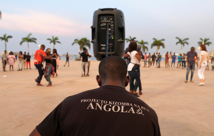 People dance Kizomba as DJ plays on a beach in Luanda, Angola, February 16, 2020.