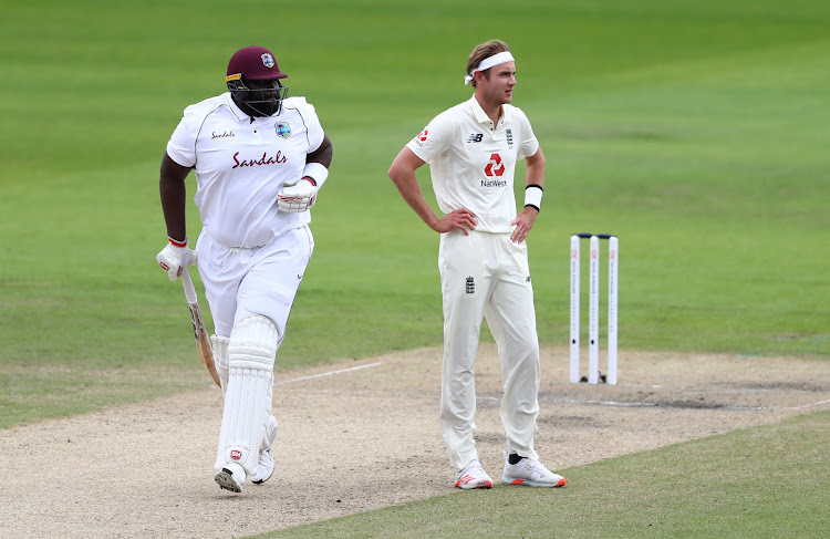 Rahkeem Cornwall runs by Stuart Broad during the third Test between England and the West Indies in July 2020 in Manchester.