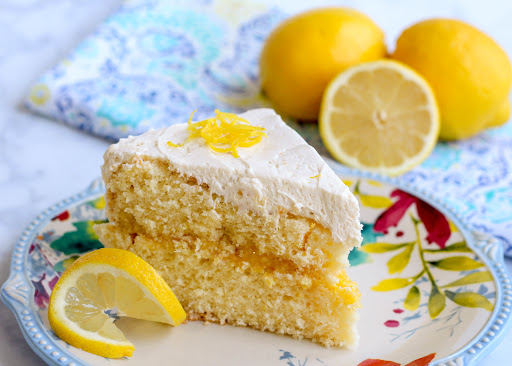 A slice of southern lemon white cake with lemon curd.