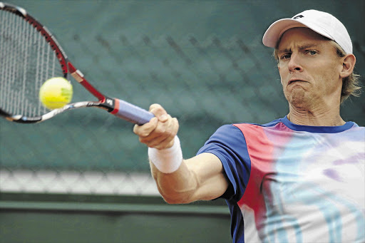 ON HIS WAY: South Africa's Kevin Anderson hits a return to France's Stephane Robert during their French Open first-round match at Roland Garros Stadium in Paris yesterday. Anderson won in straight sets