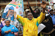 A supporter of Kenyan presidential candidate George Wajackoyah holds his poster during an election campaign rally In Gatundu, Kenya, August 3, 2022.