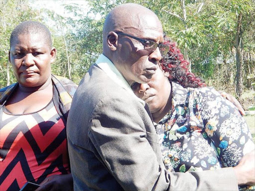 GRIEF: Sharon’s uncle Joshua Okongo consoles Melida Auma after viewing the body of her daughter at Rachuonyo Level 4 hospital mortuary in Oyugis. /ROBERT OMOLLO