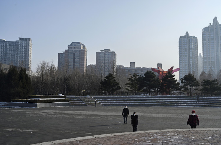 People wear masks in a nearly empty Chaoyang Park in Beijing, China, February 9 2020. Picture: Picture: KEVIN FAYER/GETTY IMAGES