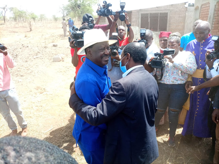 Wiper leader Kalonzo Musyoka, and ODM leader and presidential aspirant Raila Odinga hug happily when they arrived for the consecration of 10 ATG church bishops at the Revelation City Prayer Park at Kwa Muthusi in Mwingi West.