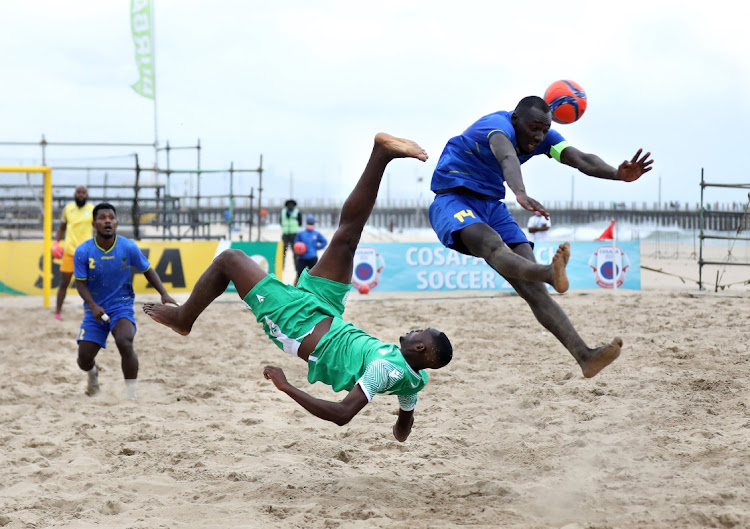 Tanzanian Captain Ismail Gambo blocks a bicycle kick by Moeva Charika of Comoros during the COSAFA Beach Soccer Tournament in Durban. Image: SANDILE NDLOVU