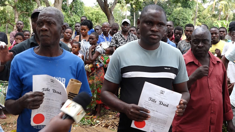 Victims of demolition show their title deeds in Malindi subcounty