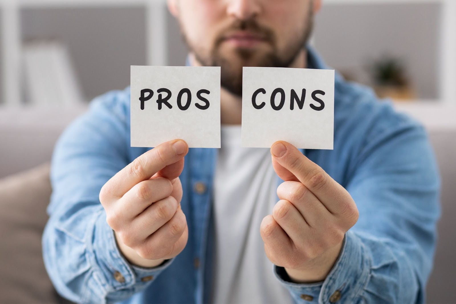 man-holding-post-its-pros-cons-list