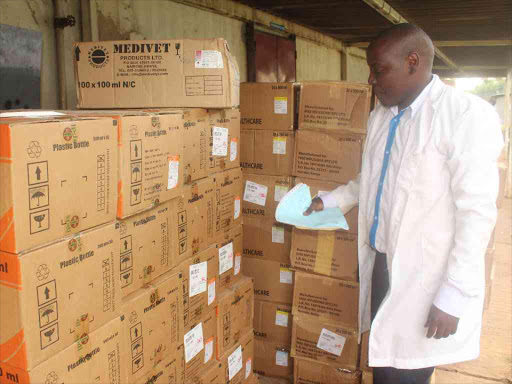 CAPTION KERICHO APRIL.17TH A phamarsists, Richard Korir at Kericho district hospital inspecting a sh.2.5 million worth of drugs,county government bought for the hospital.The drug consignment comes at time local residents have complained of drug shortgage in most health facilties in the county. Picture two. Health principal secretary Dr Nicholas Muraguri with Kericho governor Prof Paul Chepkwony.The two met at Kapkatet hospital in Bureti subcounty where Dr Muraguri officialy opened Renal Unit for dialysis service at the hospital Pictures by Sonu Tanu