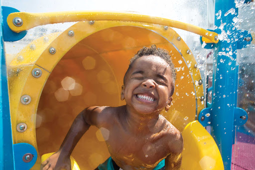 A young boy loves the waterslide action at Splashaway Bay on Harmony of the Seas. 