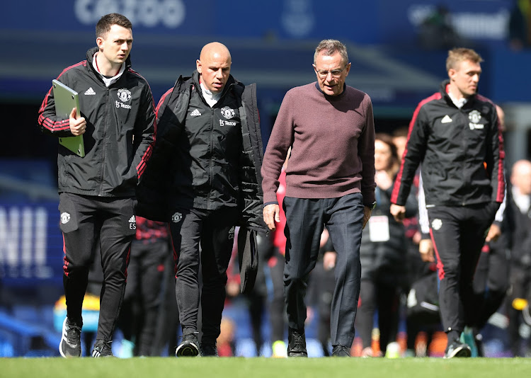 Manchester United interim manager Ralf Rangnick speaks with coaches Ewan Sharp and Chris Armas during their match against Everton