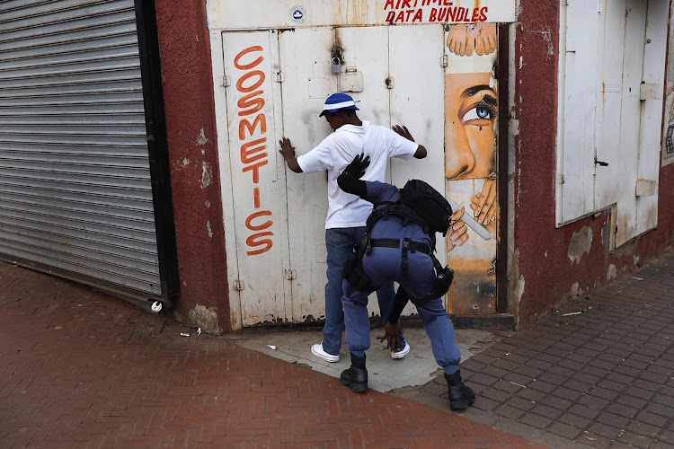 Police conduct stop-and-search operations in Yeoville, Johannesburg.