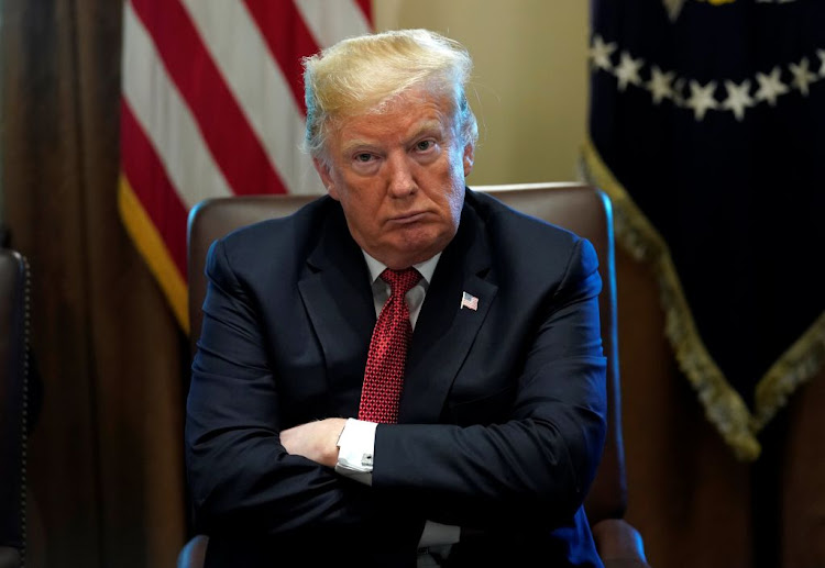 US President Donald Trump looks up as he holds a Cabinet meeting at the White House in Washington, US, on October 17 2018.